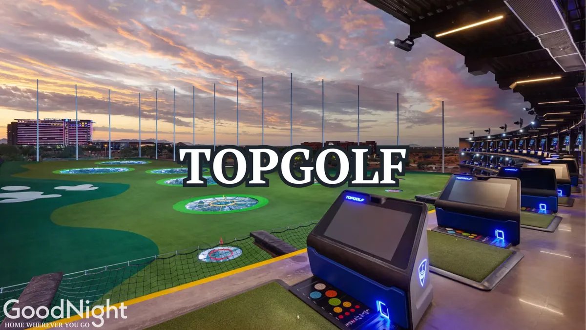 A dynamic view of Topgolf at night, with illuminated golf bays, targets, and signage, showcasing a fun, energetic setting perfect for group entertainment and nightlife.