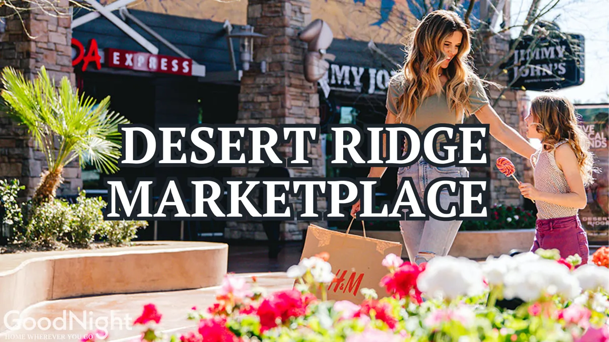 A lively outdoor retail scene with people shopping, vibrant storefronts, and lush landscaping, capturing the energy and appeal of a popular shopping and dining destination.